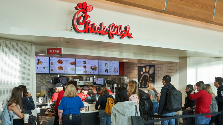 A busy Chick-Fil-A storefront inside of a building.