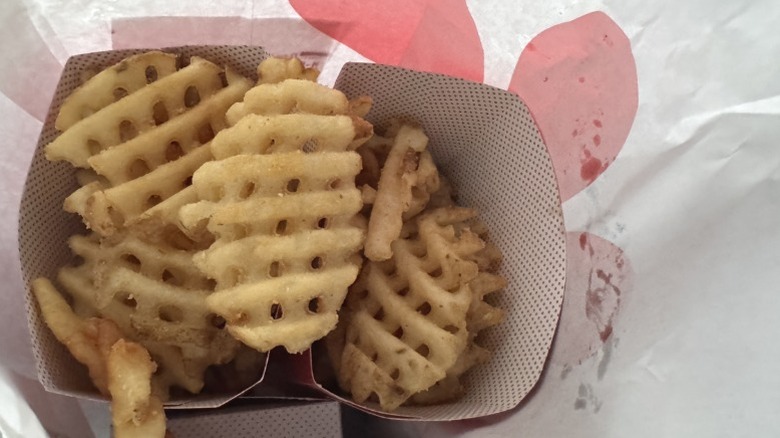 Top view into a paper bag of Chick-fil-A waffle fries