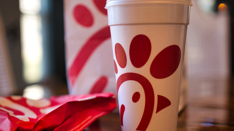 A Chick-Fil-A cup alongside other menu items on a table