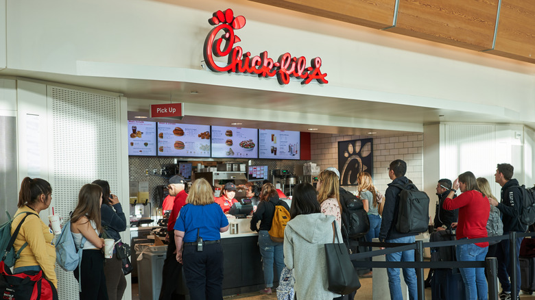 A busy Chick-Fil-A storefront inside of a building.