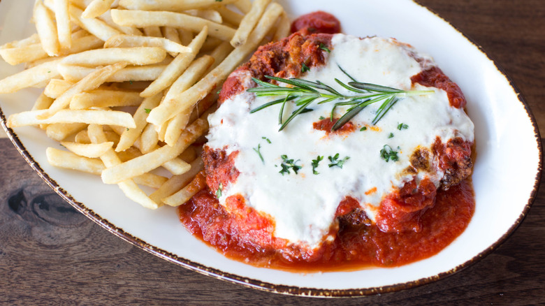 chicken parmesan on platter with french fries