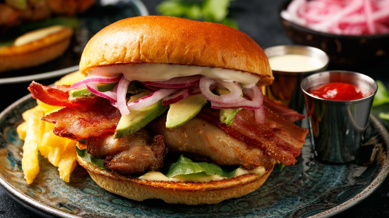 Bacon chicken sandwich with toppings on plate