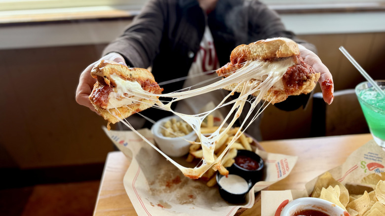 Cheese pull of Chili's Chicken Parm Big Crispy sandwich