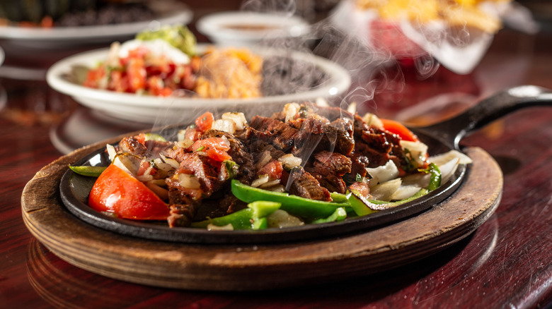 Platter of sizzling steak fajitas
