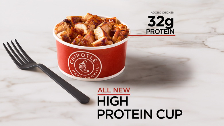 The Chipotle High Protein Cup on a marble surface near a plastic fork