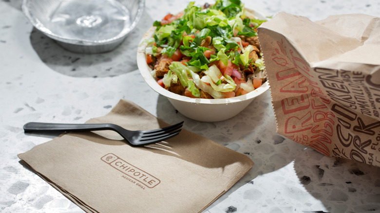 Chipotle Burrito Bowl with fork and bag nearby.