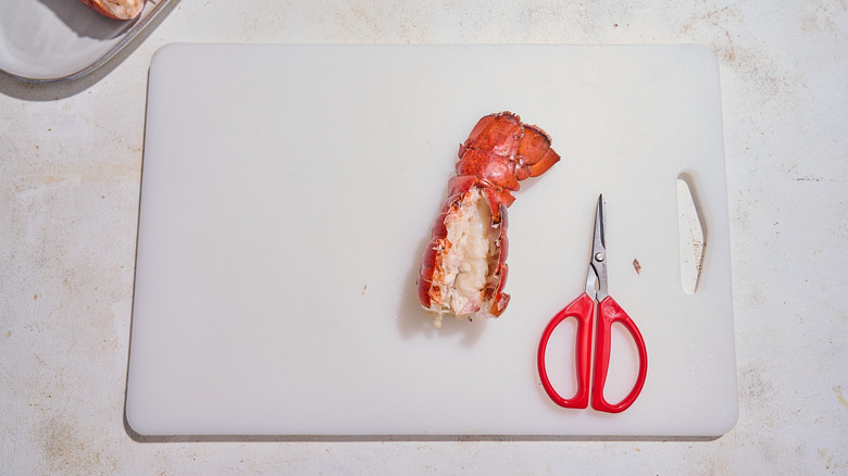 Cutting lobster shells open to reveal the meat