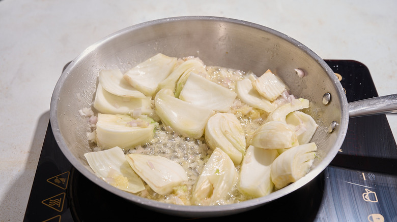 cooking fennel and shallot in a skillet