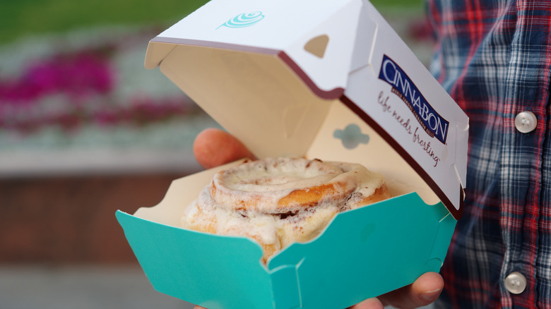 Cinnabon box with cinnamon roll inside