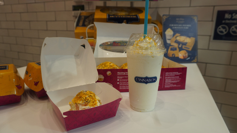 Cinnabon Butterbeer-flavored Classic Roll and Butterbeer-flavored Chillata on a store counter with packaging