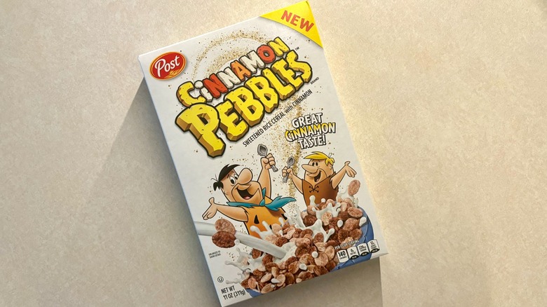 Cinnamon Pebbles cereal in a box on the counter