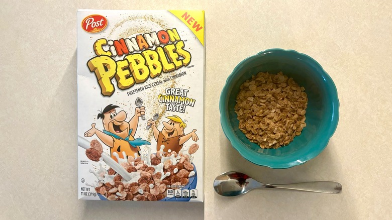 Cinnamon Pebbles box on counter and cereal in a bowl