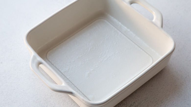 Greased square white baking dish