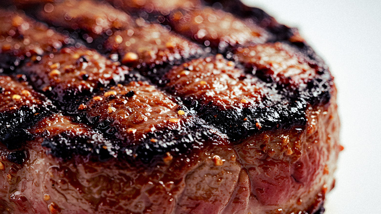 A close-up of a seared, grilled steak