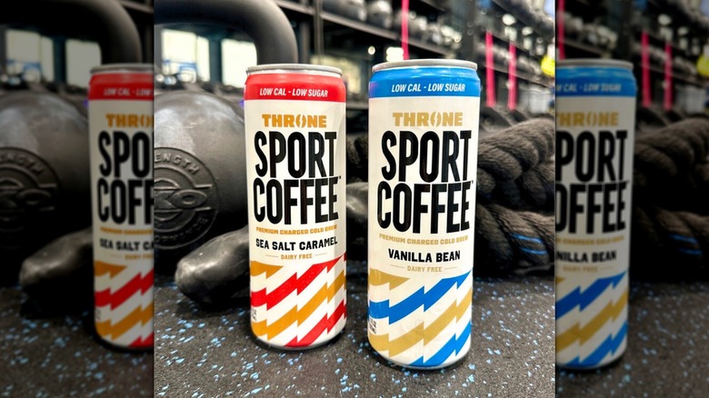 Two cans of Throne Sport Coffee co-founded by Patrick Mahomes, sea salt caramel and vanilla bean, on gym floor surrounded by equipment