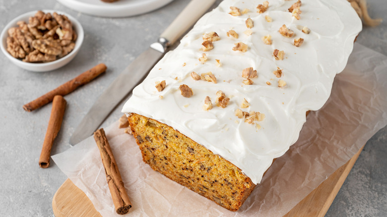 Spice loaf cake with white frosting and walnuts