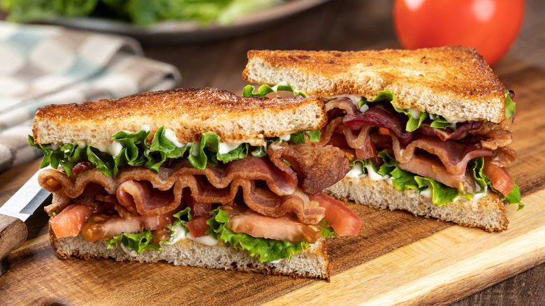 BLT sandwich on a wooden cutting board