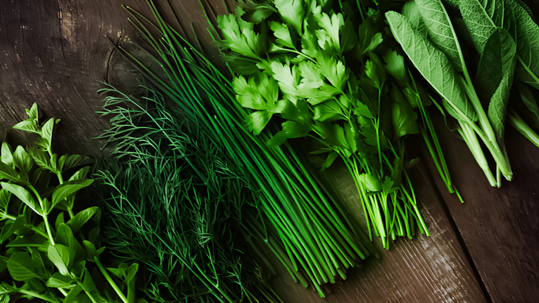 Fresh green herbs on a wooden board