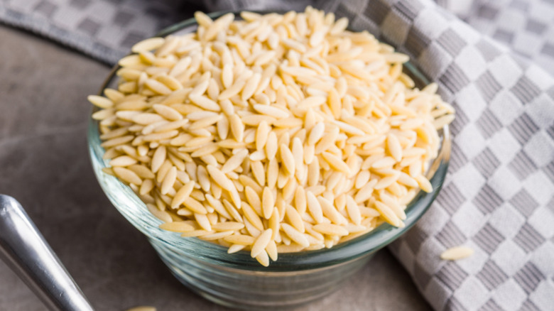 A bowl of uncooked orzo pasta