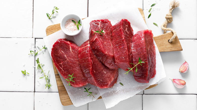 Raw beef tenderloin on a cutting board