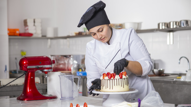 emale baker preparing strawberry cake