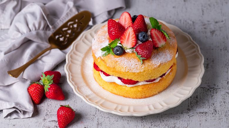 Victoria sandwich cake, decorated with strawberries, blueberries and mint