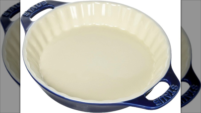 Blue Staub ceramic pie pan on white background