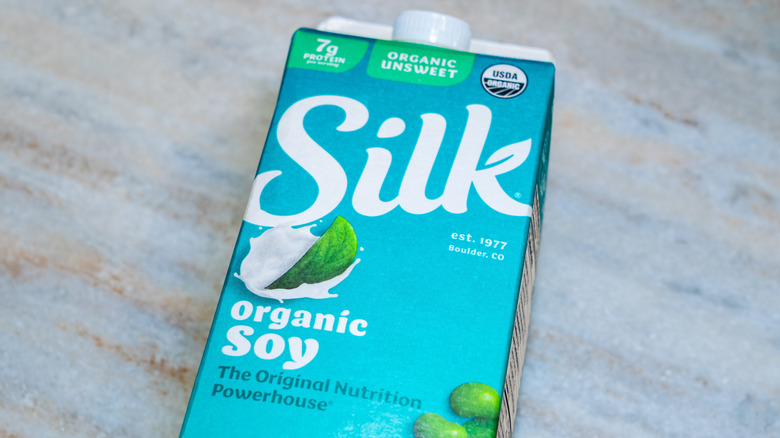 Silk soy milk carton lying flat on a counter.