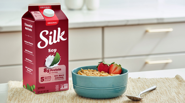 Silk soy milk carton next to bowl of cereal