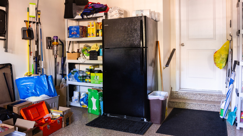 Black top-freezer refrigerator in a residential garage