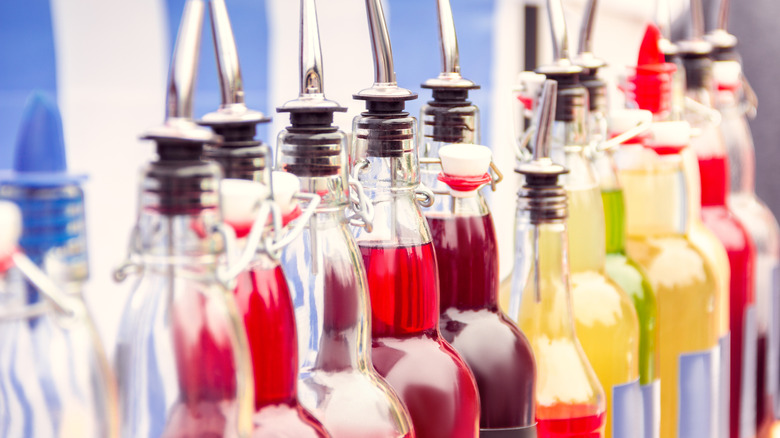 Different types of flavored syrups in glass containers