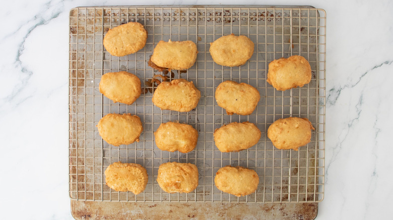 Fried chicken nuggets on wire rack