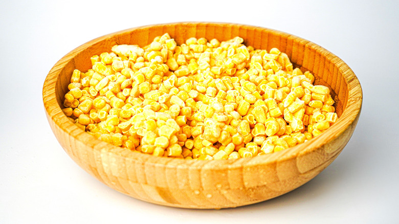 Frozen cut corn in a wooden bowl