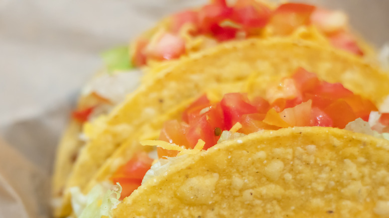 Crunchy taco shells with tomatoes and cheese