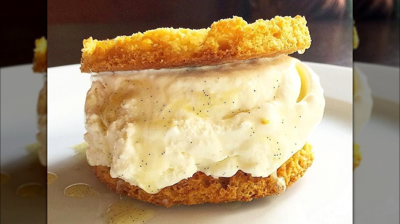 A cornbread ice cream sandwich on a white plate
