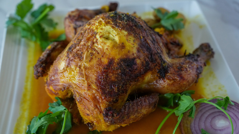 Cornish game hen with parsley and red onion