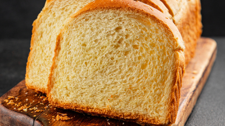 sliced brioche on a cutting wooden board
