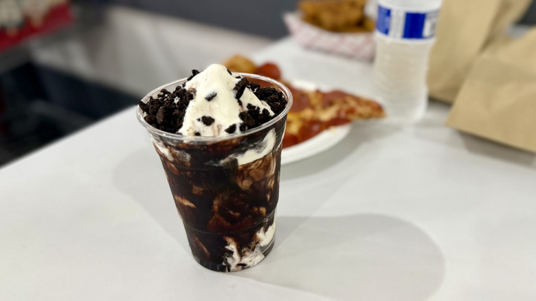 Sundae with food in the background on a white table
