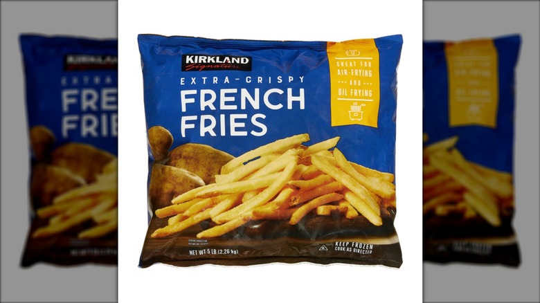 A bag of Kirkland Signature Extra Crispy French Fries on a white background.