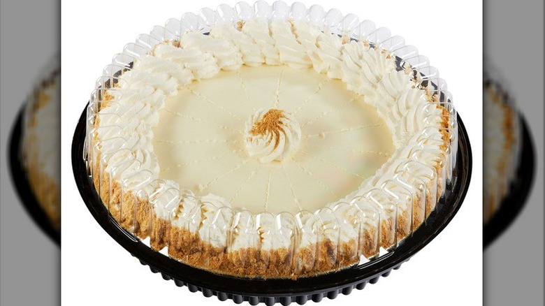 Kirkland Signature Key Lime Pie in a lidded plastic bakery container on a white background.
