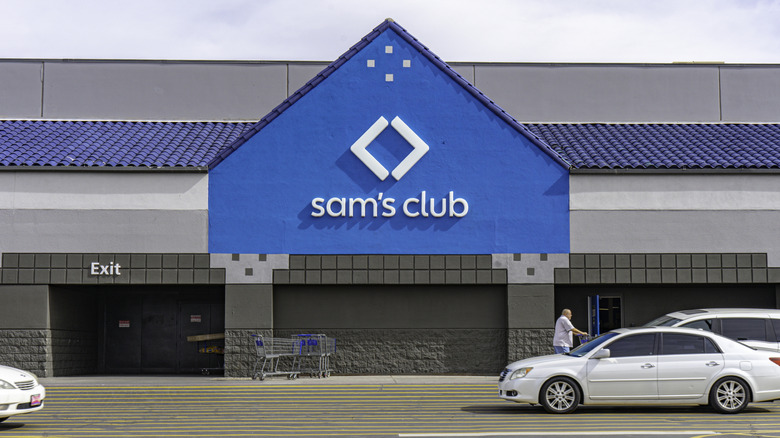 A Sam's Club storefront with cars parked nearby.