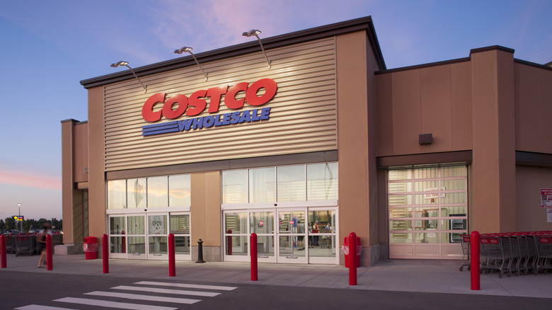 The outside of a Costco Wholesale when it is starting to get dark.