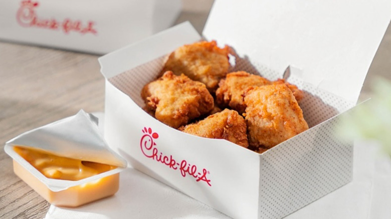 A box of Chick-fil-A nuggets with dipping sauce