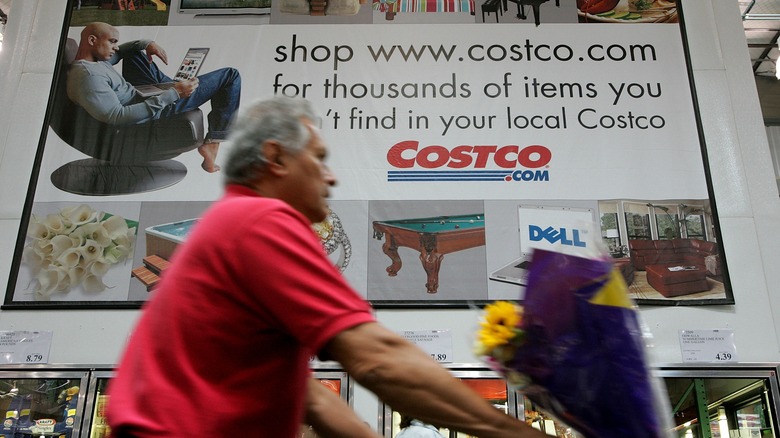 Man pushing his cart through Costco