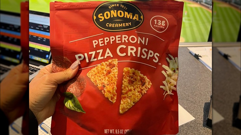 Hand holding Sonoma Creamery Pepperoni Pizza Crisps bag