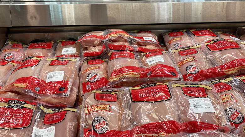 Packages of bulk chicken breasts in the meat section at Costco