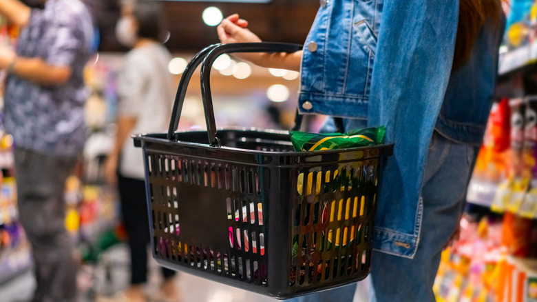 Colorful christmas gifts, shopping bags and decorations on the snow, xmas shopping concept banner