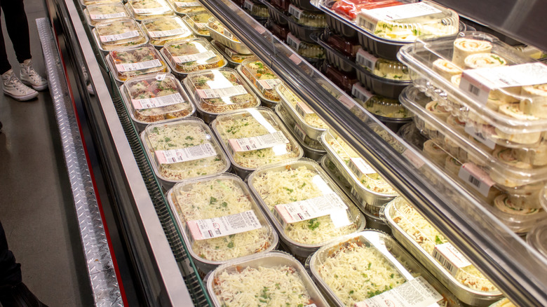 Costco refrigerated deli section featuring pasta, pinwheels, and stuffed bell peppers.