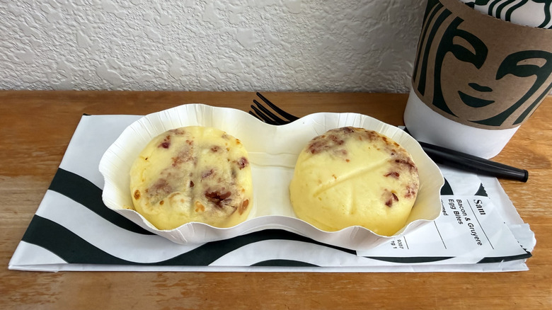 Starbucks Egg Bites on wrapper beside coffee cup
