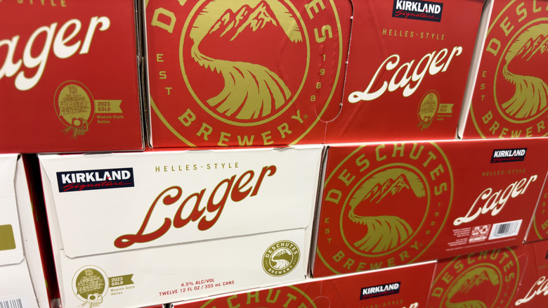 A large stack of Kirkland Signature Lager boxes at Costco.